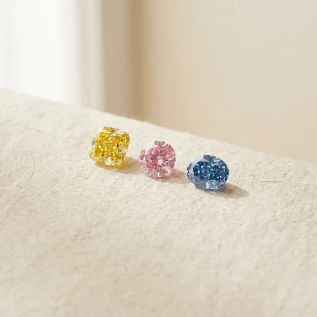 Yellow cushion, pink oval and blue oval fancy color diamonds