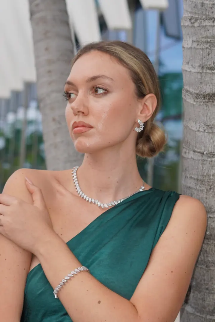 Model wearing a diamond necklace and earrings