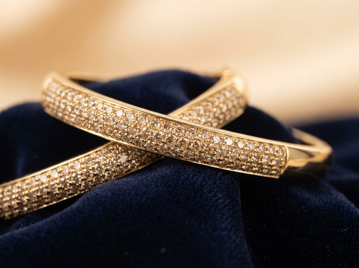Yellow gold pave bracelet set with warmer GH color natural melee diamonds, close-up macro photography on navy velvet