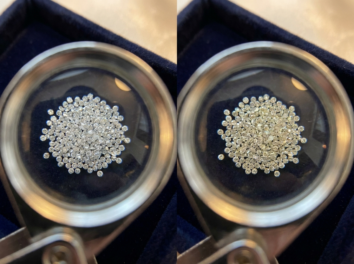 Side-by-side macro comparison of EF and GH color natural melee diamond parcels on a dark sorting tray, illustrating the subtle color difference between the two bands